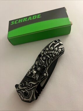 “lazy bones”. SCHA16B Skull-Engraved Folding Pocket Knife — Black and Silver